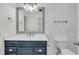 Bathroom features a navy vanity with white countertops, tiled walls, and a stylish mirror at 108 Williamsburg Ct, Goose Creek, SC 29445