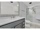 Modern bathroom with a gray vanity, sleek fixtures, and a shower featuring textured tile at 108 Williamsburg Ct, Goose Creek, SC 29445
