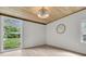 Bright bedroom with natural light, wood paneling, and a view of the backyard at 108 Williamsburg Ct, Goose Creek, SC 29445