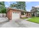 Charming one-story brick home with an attached garage, landscaped front yard, and a concrete driveway at 108 Williamsburg Ct, Goose Creek, SC 29445