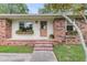 Charming exterior of a brick home featuring a wood door and garden boxes under the windows at 108 Williamsburg Ct, Goose Creek, SC 29445