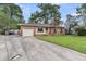 Charming single-story brick home with a well-manicured lawn, attached garage, and a long concrete driveway at 108 Williamsburg Ct, Goose Creek, SC 29445