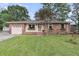 Charming brick home featuring well-maintained lawn, flower boxes, and an attached one-car garage at 108 Williamsburg Ct, Goose Creek, SC 29445