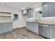 Functional kitchen featuring blue cabinets, granite countertops, and stainless steel appliances with a door at 108 Williamsburg Ct, Goose Creek, SC 29445