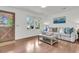 Bright and airy living room with hardwood floors, stylish furniture, and natural light streaming through the window at 108 Williamsburg Ct, Goose Creek, SC 29445