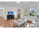 Beautiful living room boasting hardwood floors, large windows, and tasteful decor for a serene ambiance at 108 Williamsburg Ct, Goose Creek, SC 29445