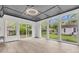 Bright sunroom featuring floor-to-ceiling windows, gray tray ceiling, and a view of the private backyard at 108 Williamsburg Ct, Goose Creek, SC 29445