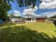 Backyard featuring a lawn, above ground pool, sheds, and the back of the house at 1110 Pickett St, Moncks Corner, SC 29461