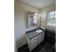 A full bathroom features a single sink vanity with a framed mirror and black tiled flooring at 1110 Pickett St, Moncks Corner, SC 29461