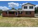 Two-story home featuring a classic brick exterior and a well-maintained lawn under a partly cloudy blue sky at 1110 Pickett St, Moncks Corner, SC 29461