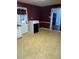 A corner of the kitchen offers a glimpse of a white door, alongside red walls and checkerboard floor at 1110 Pickett St, Moncks Corner, SC 29461