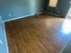 Living room featuring hardwood flooring, light blue walls, and a window with light brown curtains at 1110 Pickett St, Moncks Corner, SC 29461