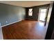 Cozy living room with laminate floors and a window with neutral drapes at 1110 Pickett St, Moncks Corner, SC 29461