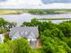 Aerial view of a townhouse community with lush green trees and a parking lot at 112 Waterfront Plantation Dr, Charleston, SC 29412