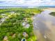 Expansive aerial view of waterfront homes surrounded by lush green trees near the marsh at 112 Waterfront Plantation Dr, Charleston, SC 29412
