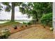 Lovely backyard brick patio, lush greenery, and water views create a perfect outdoor retreat at 112 Waterfront Plantation Dr, Charleston, SC 29412
