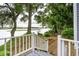 Charming backyard view with a white railing, lush greenery, and tranquil water views at 112 Waterfront Plantation Dr, Charleston, SC 29412