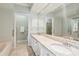 Bright bathroom featuring a double vanity with granite countertops and a soaking tub at 112 Waterfront Plantation Dr, Charleston, SC 29412