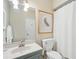 Well-lit bathroom with a sink, toilet, shower with white curtain, and light blue vanity at 112 Waterfront Plantation Dr, Charleston, SC 29412