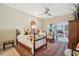 Comfortable bedroom featuring two beds, a ceiling fan, and sliding door access to outdoor balcony at 112 Waterfront Plantation Dr, Charleston, SC 29412