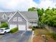 Charming townhome with a gray exterior, two-car garage, and well-maintained landscaping at 112 Waterfront Plantation Dr, Charleston, SC 29412