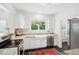 Bright and airy kitchen featuring granite counters, white cabinetry, stainless appliances, and large farmhouse sink at 112 Waterfront Plantation Dr, Charleston, SC 29412