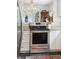 Modern kitchen featuring stainless steel stove, white cabinets, granite countertops, and stylish backsplash at 112 Waterfront Plantation Dr, Charleston, SC 29412