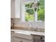 Bright kitchen featuring a farmhouse sink, stainless fixtures, granite countertops, and garden window at 112 Waterfront Plantation Dr, Charleston, SC 29412