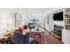 Bright living room features a fireplace, hardwood floors, a plush rug, and large windows for ample natural light at 112 Waterfront Plantation Dr, Charleston, SC 29412