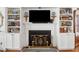Spacious living room with fireplace, built-in bookshelves, and hardwood floors at 112 Waterfront Plantation Dr, Charleston, SC 29412