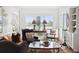Comfortable sitting area boasts large windows with stunning lake views, providing a serene and inviting atmosphere at 112 Waterfront Plantation Dr, Charleston, SC 29412