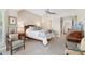Comfortable main bedroom with a seating area, plush carpet, ceiling fan, and neutral colors at 112 Waterfront Plantation Dr, Charleston, SC 29412