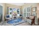 Inviting sitting area with a view, comfortable chairs, blue accents, and shuttered windows at 112 Waterfront Plantation Dr, Charleston, SC 29412