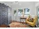 Bright sunroom features vintage cabinet and scenic lake view at 112 Waterfront Plantation Dr, Charleston, SC 29412