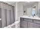 Well-lit bathroom featuring a shower-tub combo, grey vanity, and white countertop at 113 Alpine Rd, Summerville, SC 29485