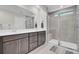 Modern bathroom features double vanity, large mirror, and glass enclosed shower offering a spa retreat at 113 Alpine Rd, Summerville, SC 29485