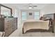 Bright bedroom features a ceiling fan, two windows, and wooden furniture providing comfort at 113 Alpine Rd, Summerville, SC 29485