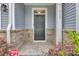 Inviting front door of home with brick accents and decorative plants for a welcoming entrance at 113 Alpine Rd, Summerville, SC 29485