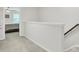 Neutral hallway features a stairway and doorway into bedroom, creating a seamless transition at 113 Alpine Rd, Summerville, SC 29485
