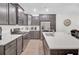 Well-lit kitchen featuring a center island with a sink, stainless steel appliances and dark cabinets at 113 Alpine Rd, Summerville, SC 29485