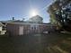 Exterior view of a brick house with a door and windows surrounded by green grass in the backyard at 1138 Landsdowne Dr, Charleston, SC 29412