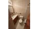 Bathroom with a single sink vanity, floral wallpaper and ceramic tile flooring at 1138 Landsdowne Dr, Charleston, SC 29412