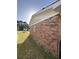 Side view of the brick house showcasing a window and a well-maintained lawn at 1138 Landsdowne Dr, Charleston, SC 29412