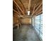 Spacious unfinished garage with concrete floor, exposed wood, storage, and a functional garage door at 1138 Landsdowne Dr, Charleston, SC 29412