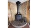 Corner view of a rustic wood burning stove with red brick surround and accessories at 1138 Landsdowne Dr, Charleston, SC 29412
