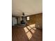 Living room with wood-look flooring and a rustic brick fireplace at 1138 Landsdowne Dr, Charleston, SC 29412