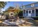 Outdoor dining area with brick oven, a large sun umbrella, and screened-in porch at 1153 King St, Charleston, SC 29403