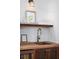 Close-up of a bar area featuring a wooden countertop, sink, and stocked beverage cooler at 1153 King St, Charleston, SC 29403