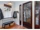 Inviting entryway with a bench, coat hooks, and a glass-paneled door allowing ample natural light at 1153 King St, Charleston, SC 29403