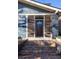 Charming front porch featuring brick steps and a beautiful wood front door with sidelight windows at 1153 King St, Charleston, SC 29403